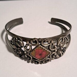 Silver tone detailed metal bracelet with flower and heart design